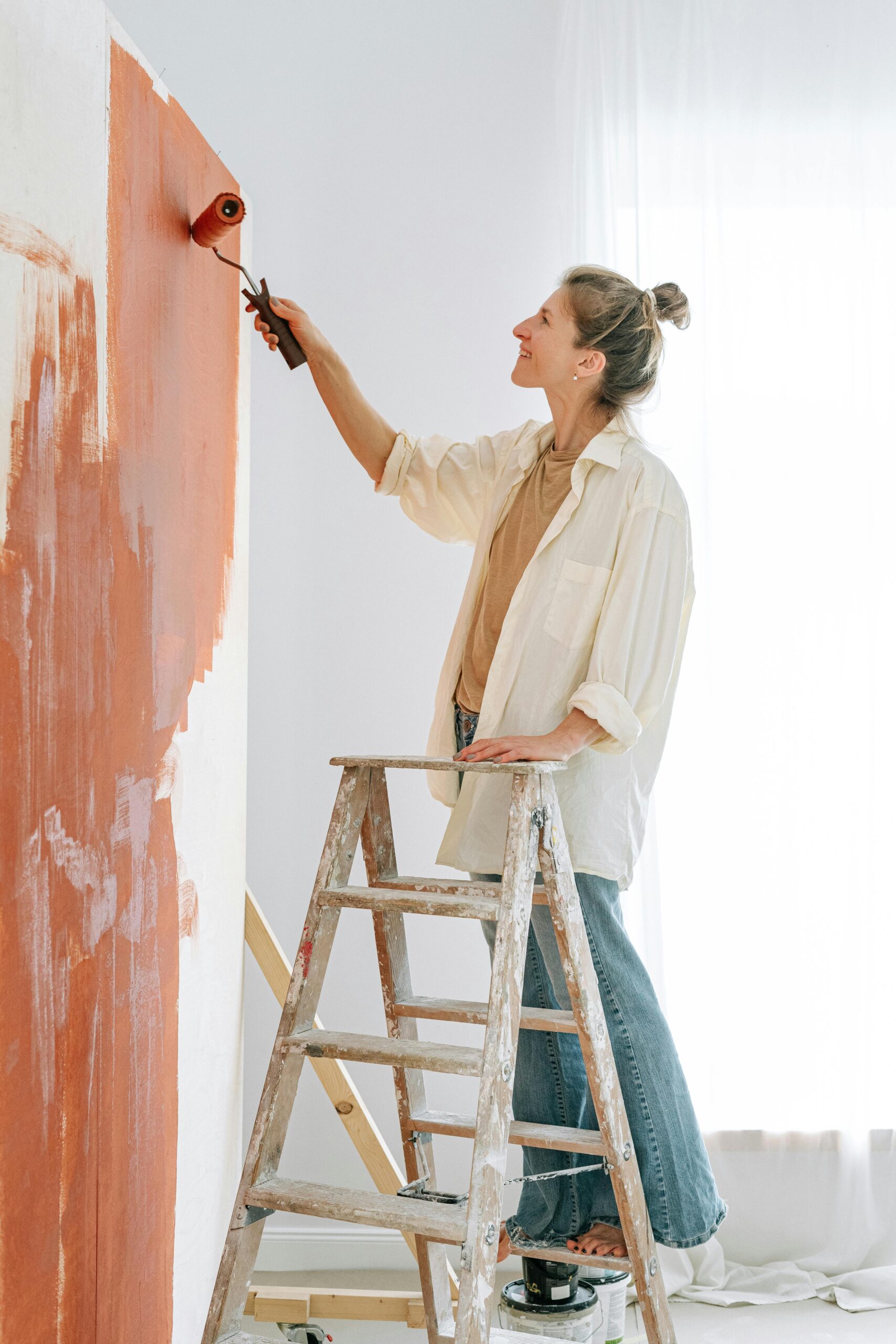A Classic Touch Painting expert applying color to coastal home exterior