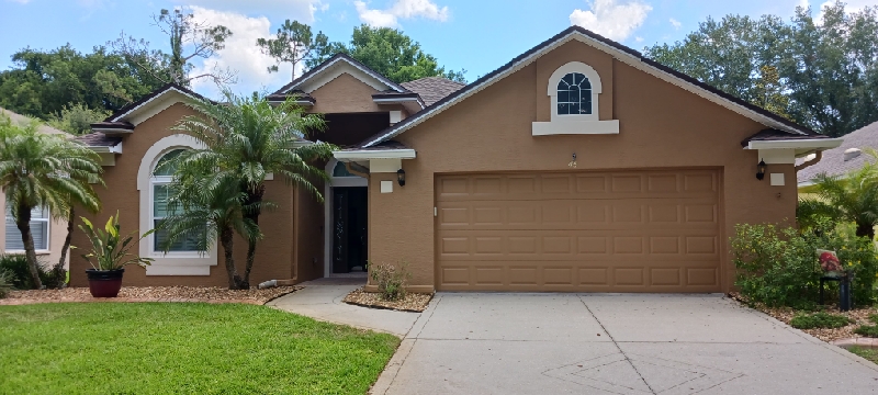 Professional painter working on home exterior in Flagler County, FL